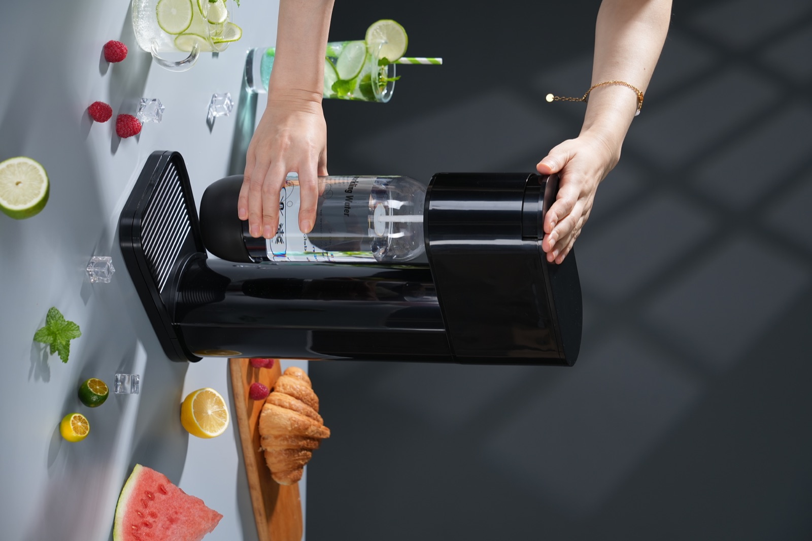 NS-SM01 shown with a hand on the top button and another holding the fitted bottle